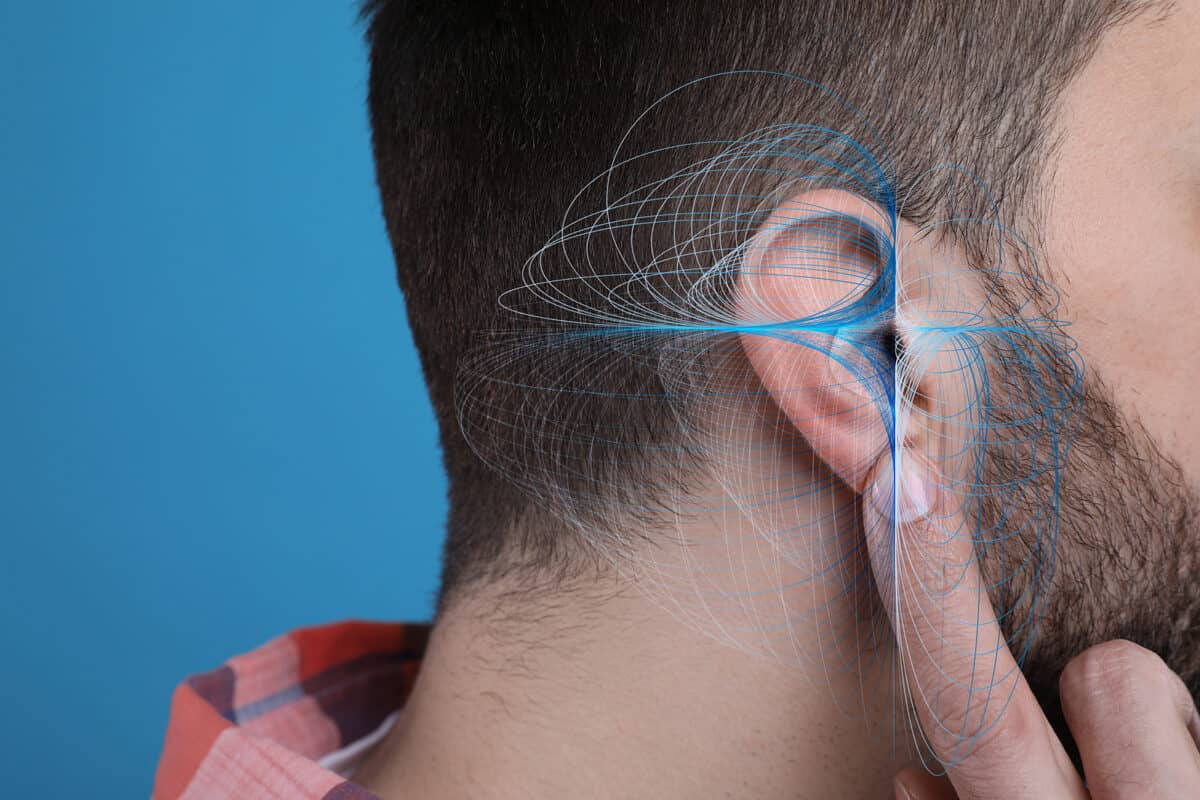 Hearing Loss Concept. Man And Sound Waves Illustration On Light